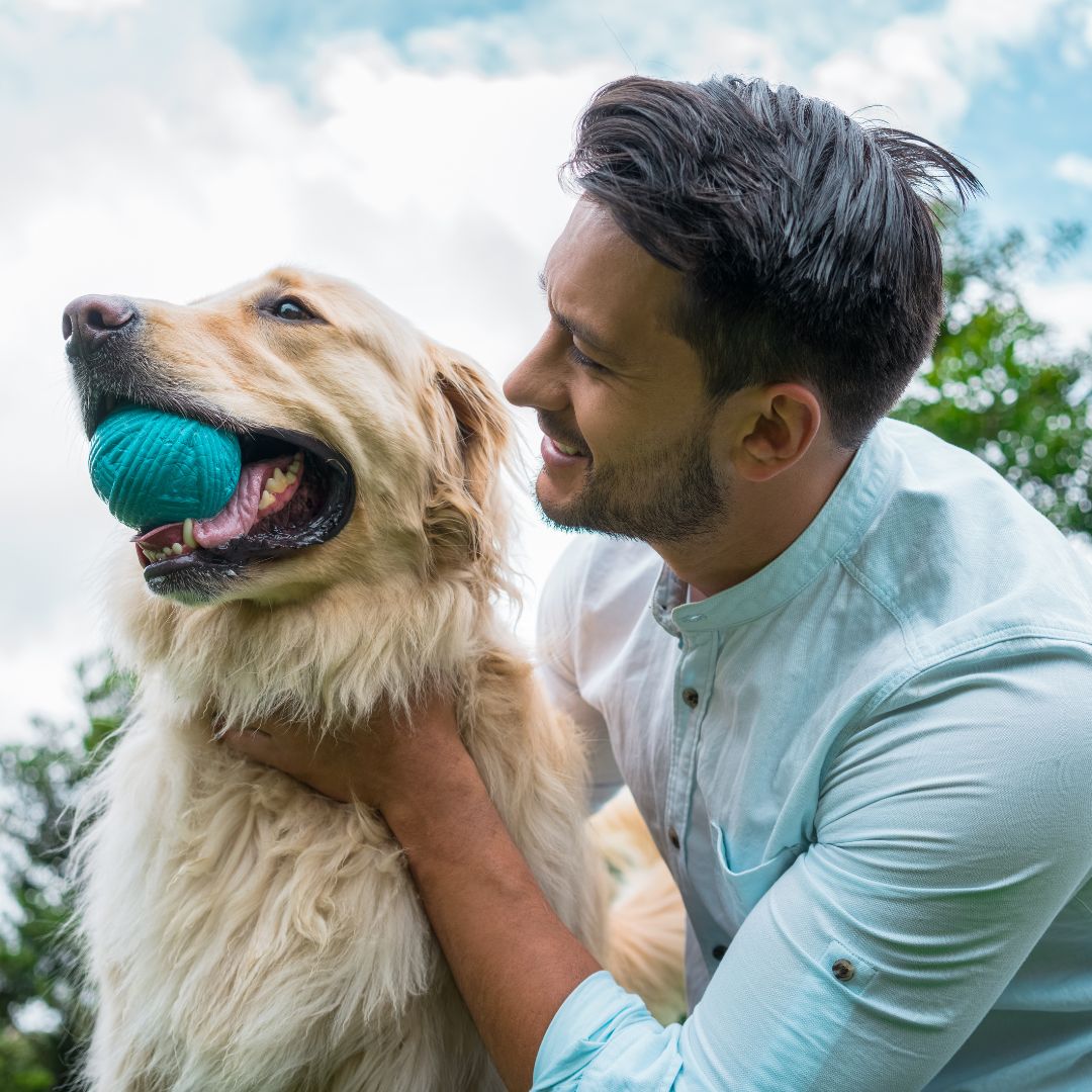 A man and his dog share a playful moment